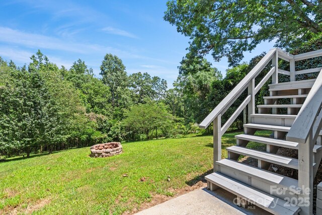 211 Woodland Rd, Tryon, NC 28782 - view of grassy yard with an outdoor fire pit and stairway