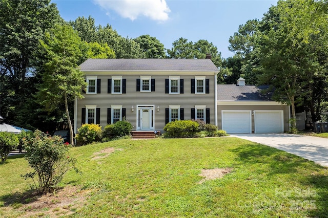 1109 Sunnyview Cir, Matthews, NC 28105 - colonial house with a chimney, an attached garage, driveway, and a front lawn