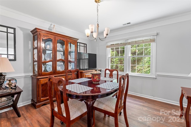 1109 Sunnyview Cir, Matthews, NC 28105 - dining area with a chandelier, wood finished floors, and crown molding