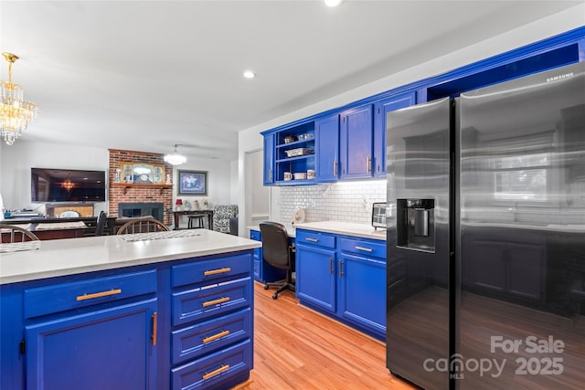1109 Sunnyview Cir, Matthews, NC 28105 - kitchen featuring stainless steel refrigerator with ice dispenser, a fireplace, light countertops, backsplash, and recessed lighting
