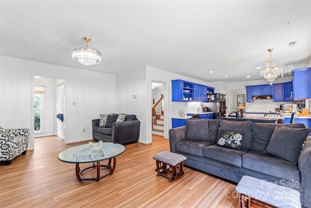 1109 Sunnyview Cir, Matthews, NC 28105 - living area with a chandelier, light wood-style floors, and stairs