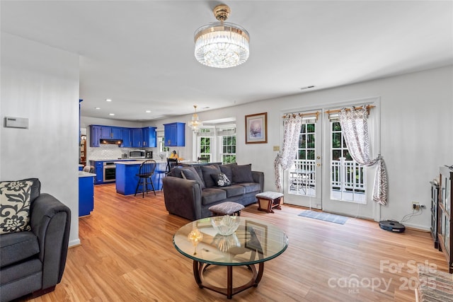 1109 Sunnyview Cir, Matthews, NC 28105 - living room with french doors, a chandelier, light wood-type flooring, and recessed lighting
