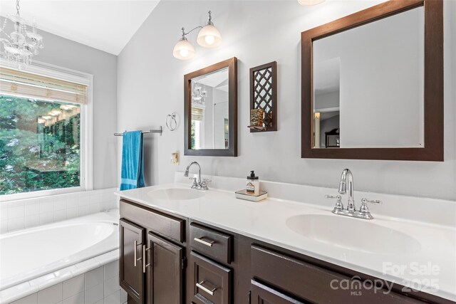 1109 Sunnyview Cir, Matthews, NC 28105 - full bath with double vanity, a garden tub, and vaulted ceiling