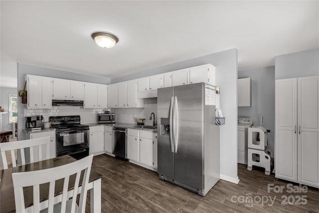 2460 Prince Dr, Lancaster, SC 29720 - kitchen with appliances with stainless steel finishes, under cabinet range hood, dark wood-style floors, and white cabinets