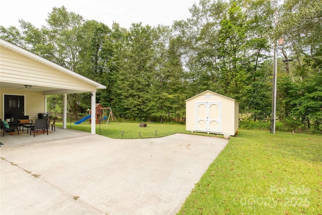 2460 Prince Dr, Lancaster, SC 29720 - view of patio featuring a storage shed, a playground, and view of scattered trees