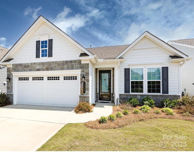 7337 Overjoyed Xing, Charlotte, NC 28215 - view of front facade with stone siding, concrete driveway, and an attached garage
