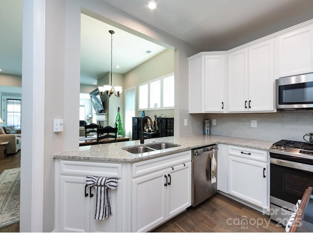 7337 Overjoyed Xing, Charlotte, NC 28215 - kitchen featuring stainless steel appliances, white cabinets, a chandelier, dark wood-type flooring, and healthy amount of natural light