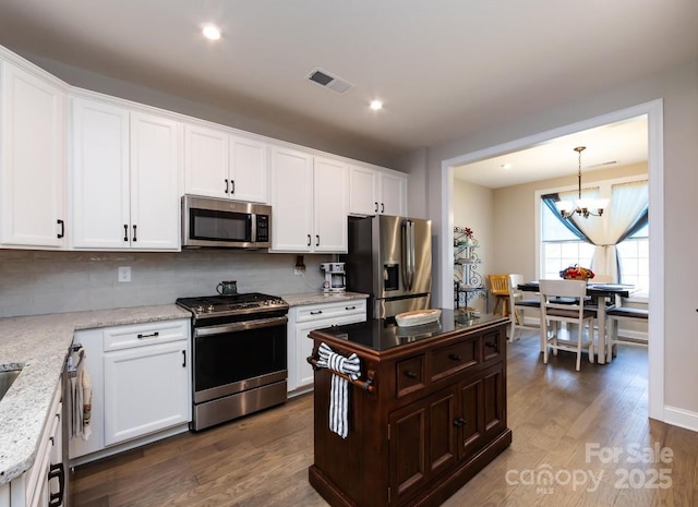 7337 Overjoyed Xing, Charlotte, NC 28215 - kitchen with stainless steel appliances, tasteful backsplash, white cabinetry, and recessed lighting