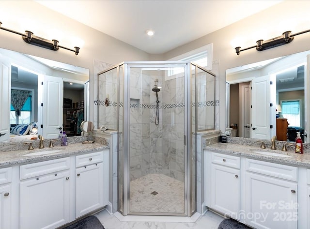 7337 Overjoyed Xing, Charlotte, NC 28215 - ensuite bathroom featuring a stall shower, two vanities, marble finish floors, and recessed lighting