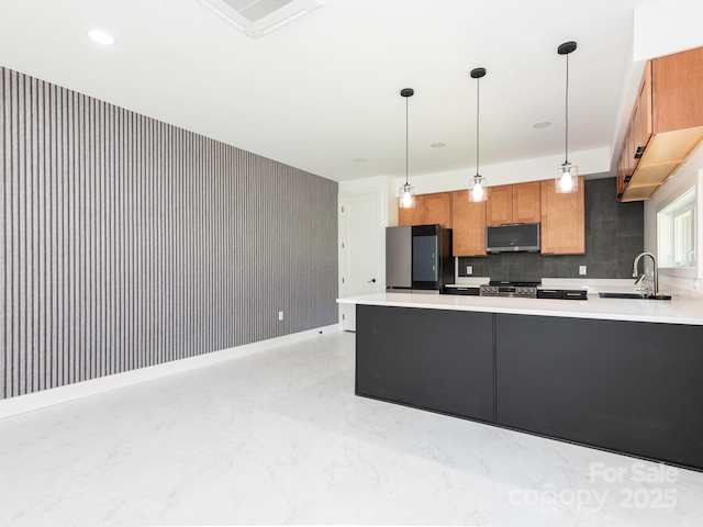 6548 Emerald Isle Dr, Sherrills Ford, NC 28673 - kitchen featuring stainless steel appliances, wallpapered walls, light countertops, a peninsula, and hanging light fixtures