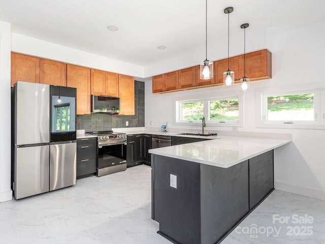 6548 Emerald Isle Dr, Sherrills Ford, NC 28673 - kitchen featuring stainless steel appliances, a peninsula, light marble finish floors, hanging light fixtures, and backsplash