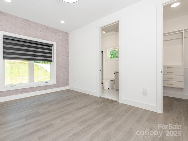 6548 Emerald Isle Dr, Sherrills Ford, NC 28673 - unfurnished bedroom featuring a walk in closet, a closet, light wood-style floors, recessed lighting, and ensuite bath