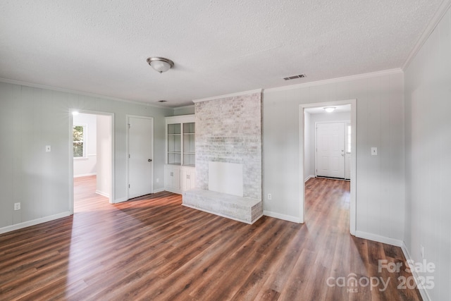 6513 Old Post Rd, Charlotte, NC 28212 - empty room featuring a textured ceiling, dark wood-style floors, and ornamental molding