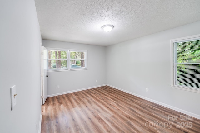 6513 Old Post Rd, Charlotte, NC 28212 - unfurnished room with a textured ceiling and light wood finished floors