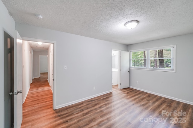 6513 Old Post Rd, Charlotte, NC 28212 - unfurnished bedroom with a textured ceiling and wood finished floors