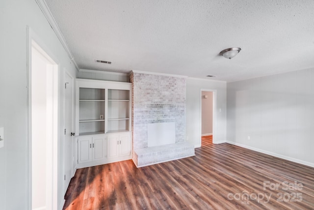 6513 Old Post Rd, Charlotte, NC 28212 - unfurnished living room with a textured ceiling, ornamental molding, wood finished floors, and a brick fireplace