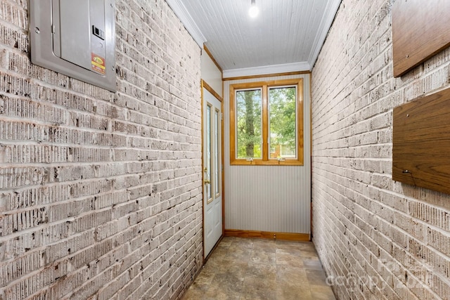 728 Blanton St, Shelby, NC 28150 - hallway featuring crown molding, electric panel, stone finish flooring, and brick wall