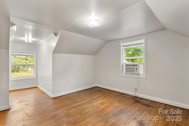728 Blanton St, Shelby, NC 28150 - additional living space featuring light wood finished floors, cooling unit, vaulted ceiling, and healthy amount of natural light