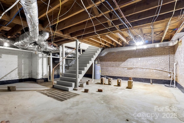 728 Blanton St, Shelby, NC 28150 - unfinished below grade area featuring electric water heater, stairs, and brick wall