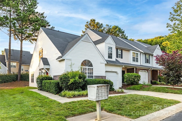 11531 Delores Ferguson Ln, Charlotte, NC 28277 - multi unit property featuring an attached garage, a front lawn, driveway, and brick siding