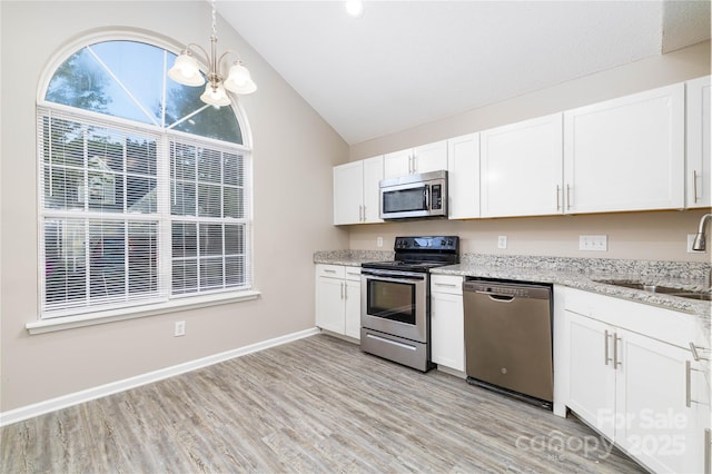 11531 Delores Ferguson Ln, Charlotte, NC 28277 - kitchen with stainless steel appliances, lofted ceiling, a chandelier, light wood finished floors, and white cabinetry