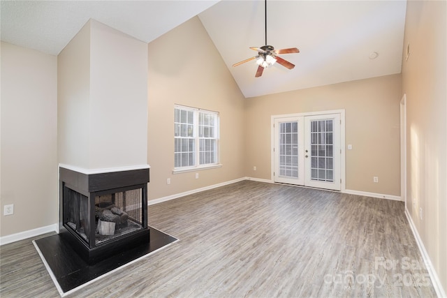 11531 Delores Ferguson Ln, Charlotte, NC 28277 - unfurnished living room featuring high vaulted ceiling, wood finished floors, a ceiling fan, and french doors
