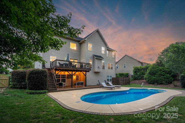 1807 Robbins Meadows Dr, Waxhaw, NC 28173 - back of house at dusk featuring stairway, a deck, an outdoor pool, and a patio area