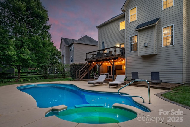 1807 Robbins Meadows Dr, Waxhaw, NC 28173 - pool at dusk featuring a deck, stairway, a pool with connected hot tub, and a patio area
