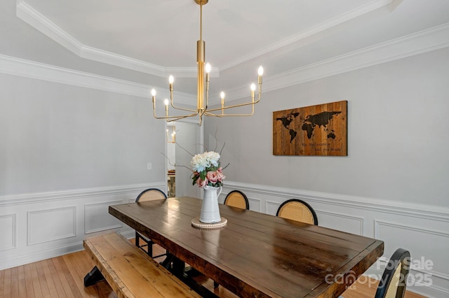 1807 Robbins Meadows Dr, Waxhaw, NC 28173 - dining area with a chandelier, a wainscoted wall, a decorative wall, ornamental molding, and light wood-type flooring