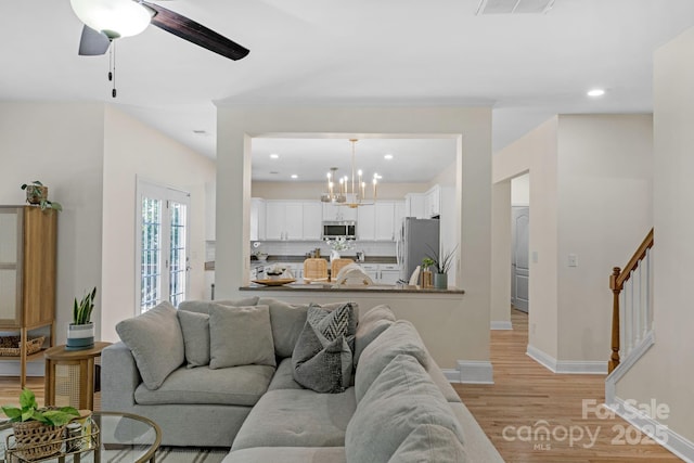 1807 Robbins Meadows Dr, Waxhaw, NC 28173 - living area featuring light wood finished floors, a chandelier, recessed lighting, and ceiling fan