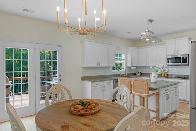 1807 Robbins Meadows Dr, Waxhaw, NC 28173 - dining area featuring light wood finished floors and a chandelier