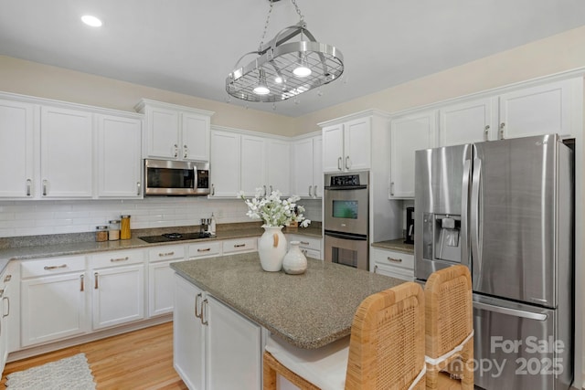 1807 Robbins Meadows Dr, Waxhaw, NC 28173 - kitchen featuring appliances with stainless steel finishes, white cabinetry, and tasteful backsplash
