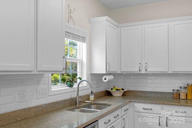 1807 Robbins Meadows Dr, Waxhaw, NC 28173 - kitchen featuring white cabinetry, decorative backsplash, and light stone counters