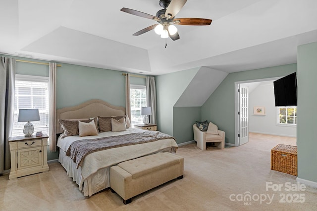1807 Robbins Meadows Dr, Waxhaw, NC 28173 - bedroom featuring light carpet, vaulted ceiling, a ceiling fan, and a raised ceiling