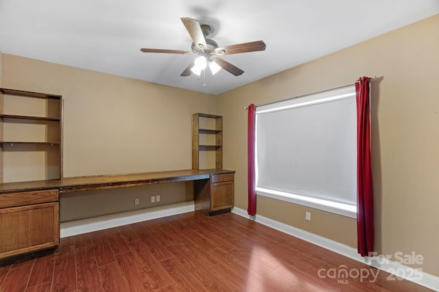 1807 Robbins Meadows Dr, Waxhaw, NC 28173 - unfurnished office with dark wood finished floors, built in study area, and ceiling fan