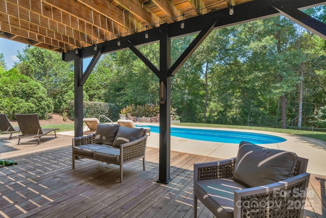 1807 Robbins Meadows Dr, Waxhaw, NC 28173 - swimming pool with a wooden deck, outdoor lounge area, and view of wooded area