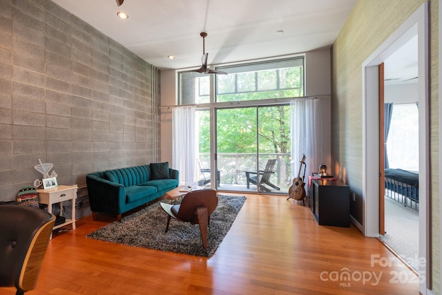2116 Mcclintock Rd Unit 122, Charlotte, NC 28205 - living room featuring wood finished floors, tile walls, recessed lighting, and an accent wall