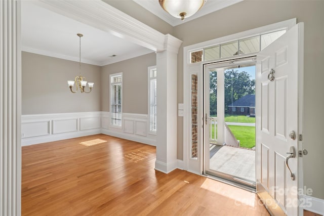 2411 Stoney Run Dr Unit 13, Oakboro, NC 28129 - foyer featuring a chandelier, ornamental molding, wainscoting, and light wood finished floors