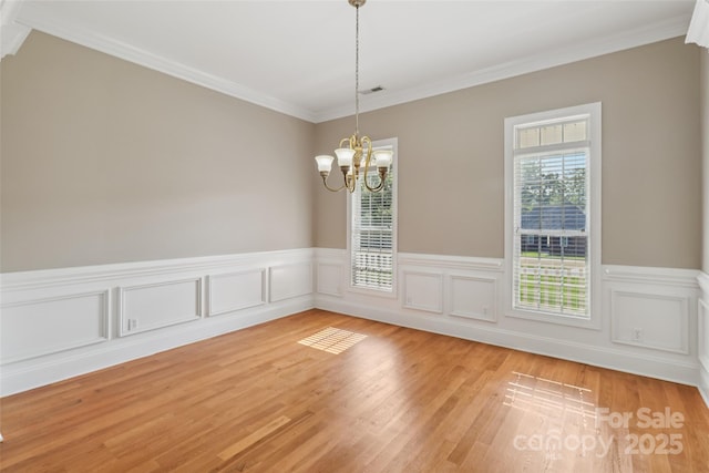 2411 Stoney Run Dr Unit 13, Oakboro, NC 28129 - unfurnished dining area with a chandelier, crown molding, light wood-style floors, and wainscoting