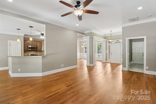 2411 Stoney Run Dr Unit 13, Oakboro, NC 28129 - unfurnished living room featuring ceiling fan, light wood-type flooring, crown molding, and recessed lighting