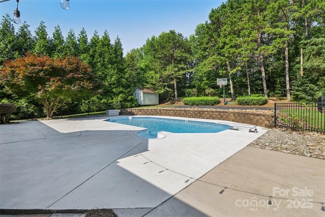 2411 Stoney Run Dr Unit 13, Oakboro, NC 28129 - view of swimming pool featuring a shed, a patio area, and a diving board