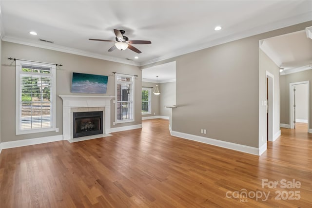 2411 Stoney Run Dr Unit 13, Oakboro, NC 28129 - unfurnished living room with ceiling fan, light wood-type flooring, ornamental molding, a tiled fireplace, and recessed lighting