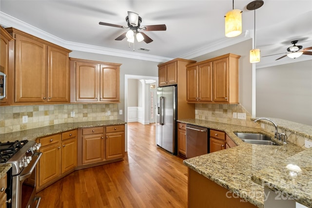 2411 Stoney Run Dr Unit 13, Oakboro, NC 28129 - kitchen with ceiling fan, stainless steel appliances, decorative light fixtures, wood finished floors, and light stone countertops