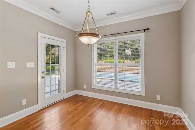 2411 Stoney Run Dr Unit 13, Oakboro, NC 28129 - unfurnished dining area with ornamental molding and wood finished floors