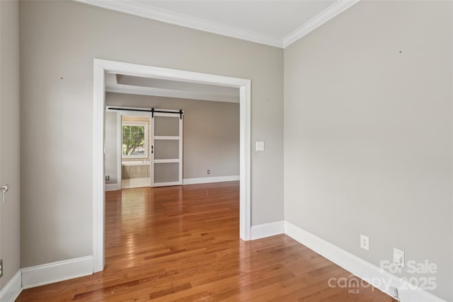 2411 Stoney Run Dr Unit 13, Oakboro, NC 28129 - empty room with crown molding, light wood-style flooring, and a barn door