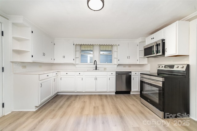 105 Mcgill Ave NW, Concord, NC 28025 - kitchen with open shelves, appliances with stainless steel finishes, light wood-style flooring, and white cabinetry