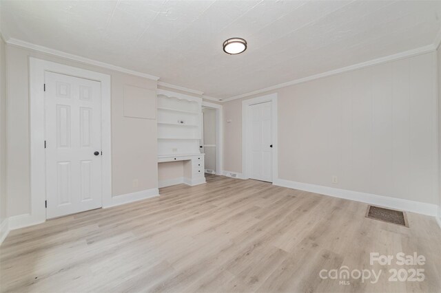 105 Mcgill Ave NW, Concord, NC 28025 - unfurnished living room featuring light wood finished floors, crown molding, and an office area