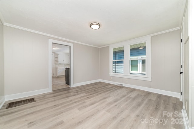 105 Mcgill Ave NW, Concord, NC 28025 - spare room with light wood-type flooring and crown molding