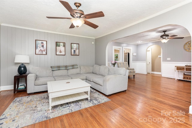 304 W Colonial Dr, Salisbury, NC 28144 - living room with arched walkways, a ceiling fan, wood finished floors, a textured ceiling, and ornamental molding