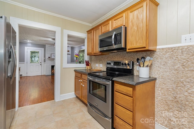 304 W Colonial Dr, Salisbury, NC 28144 - kitchen with appliances with stainless steel finishes, dark countertops, crown molding, a brick fireplace, and backsplash